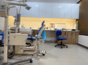 A treatment room at Dental Plus, Bahria Town, with a dental chair and overhead light